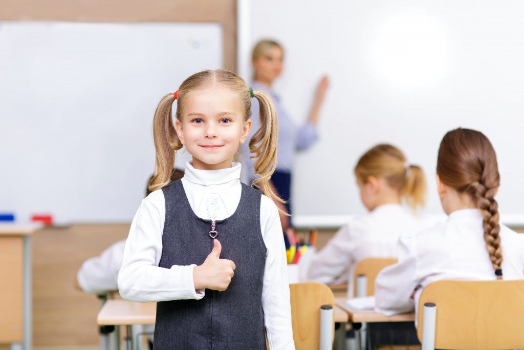 Little girl standing in the classroom