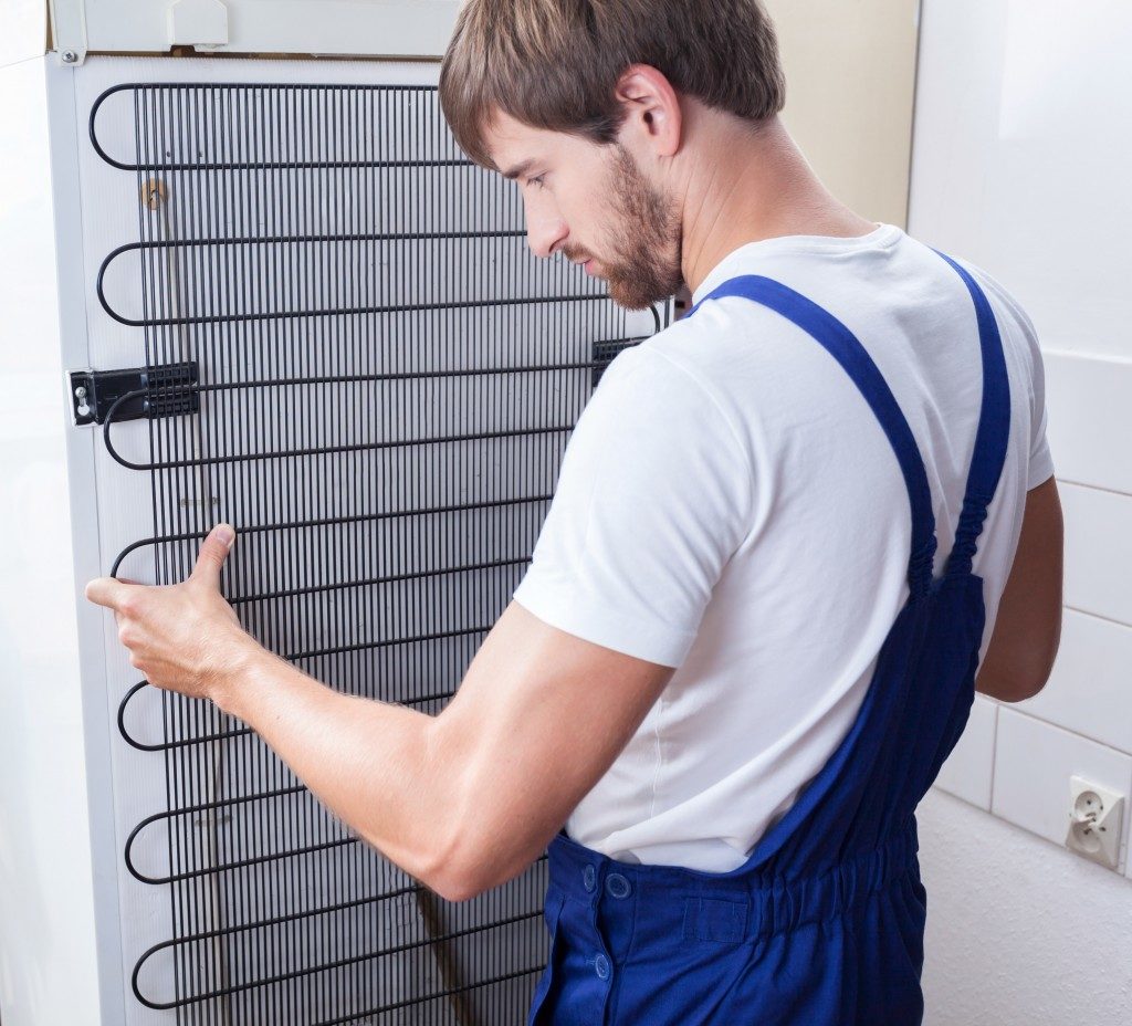 man installing fridge