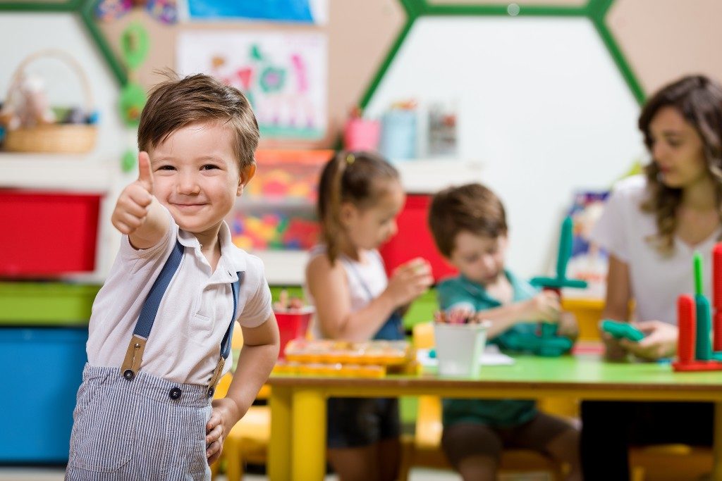 preschool student giving thumbs up